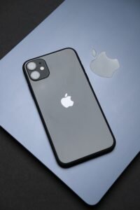 Stylish Apple iPhone on a MacBook, showcasing modern technology and design.